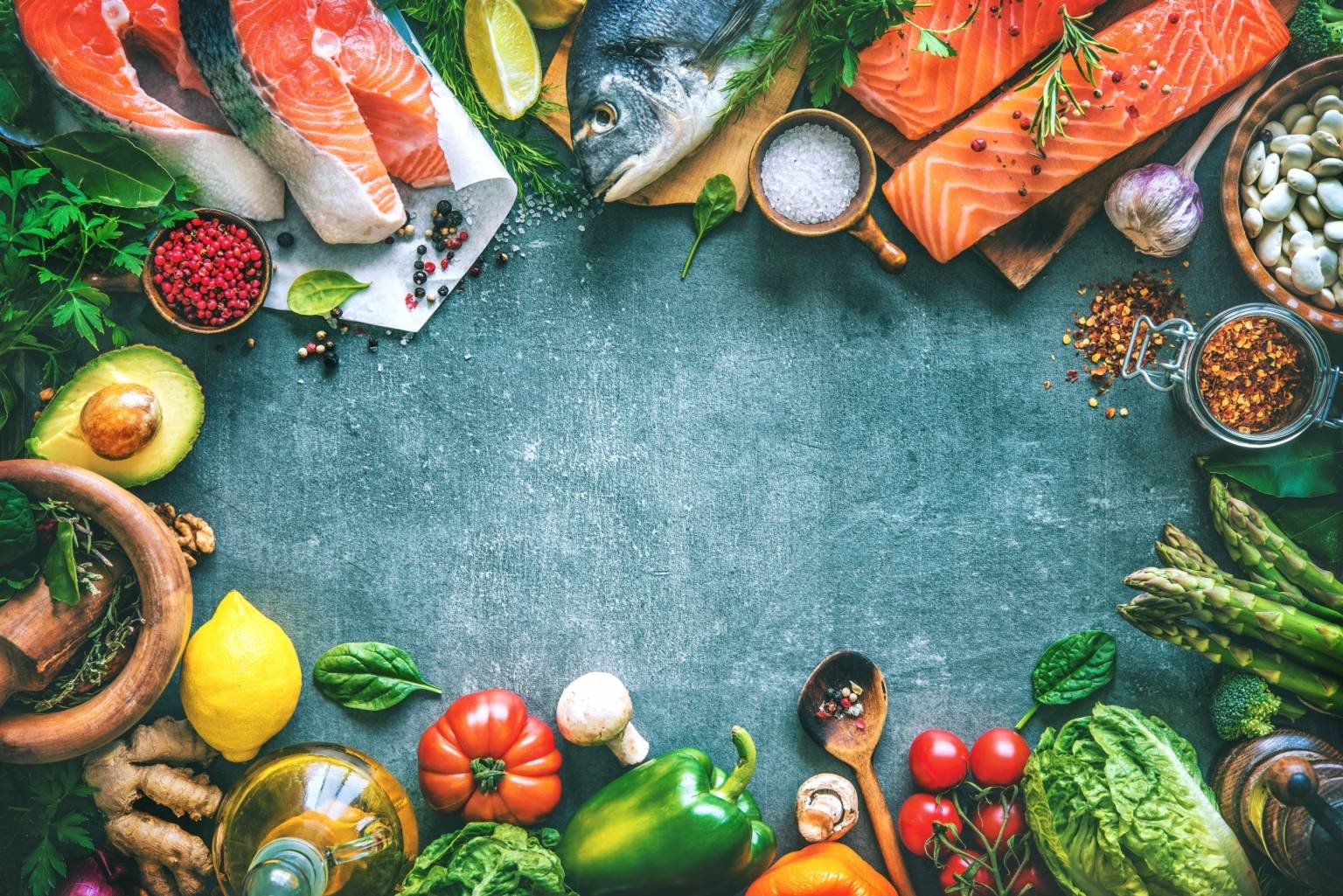 Cukrzyca typu 2 - jak ją leczyć? Na szarym tle poukładane są w kółku produkty żywnościowe: ryby, warzywa, owoce, nasiona i przyprawy.