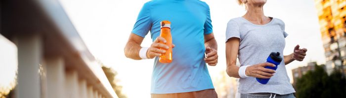 Slow jogging - sposób na długowieczność. Para seniorów biega po mieście.